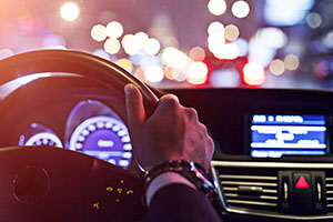 man driving at night, lights everywhere