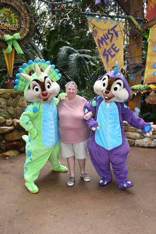 Judi posing with Disney characters