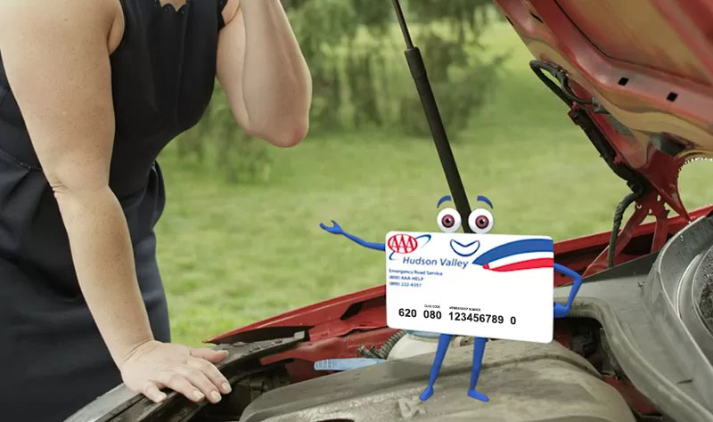 AAA card character sitting on engine of car, woman in background looking under the hood of car