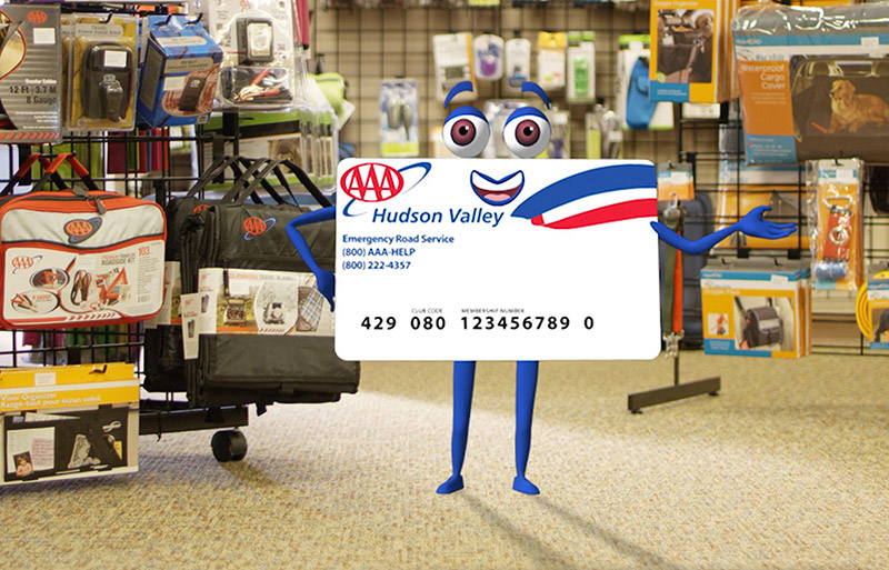 AAA card character standing in AAA travel store