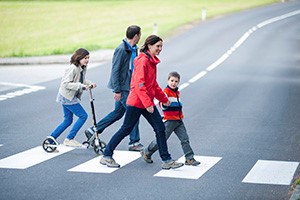 group of people crossing street at crosswalk