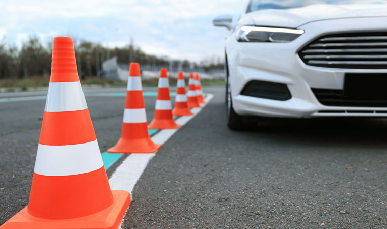 car on driving course with traffic cones