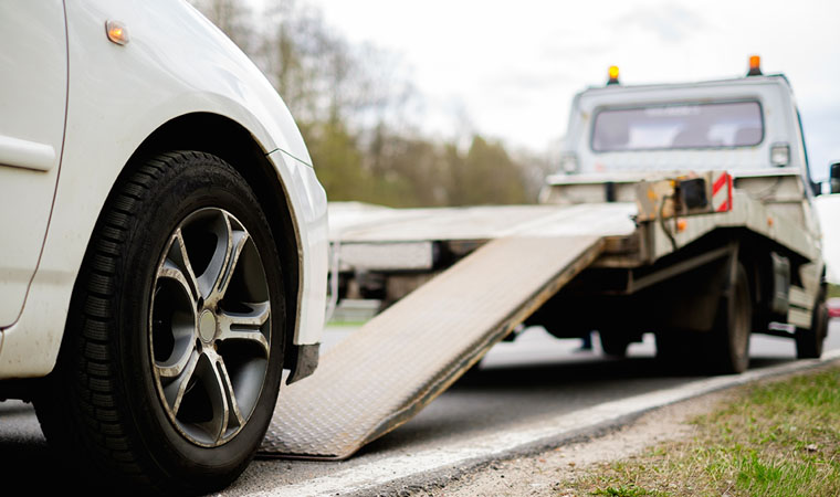 car being towed on side of highway