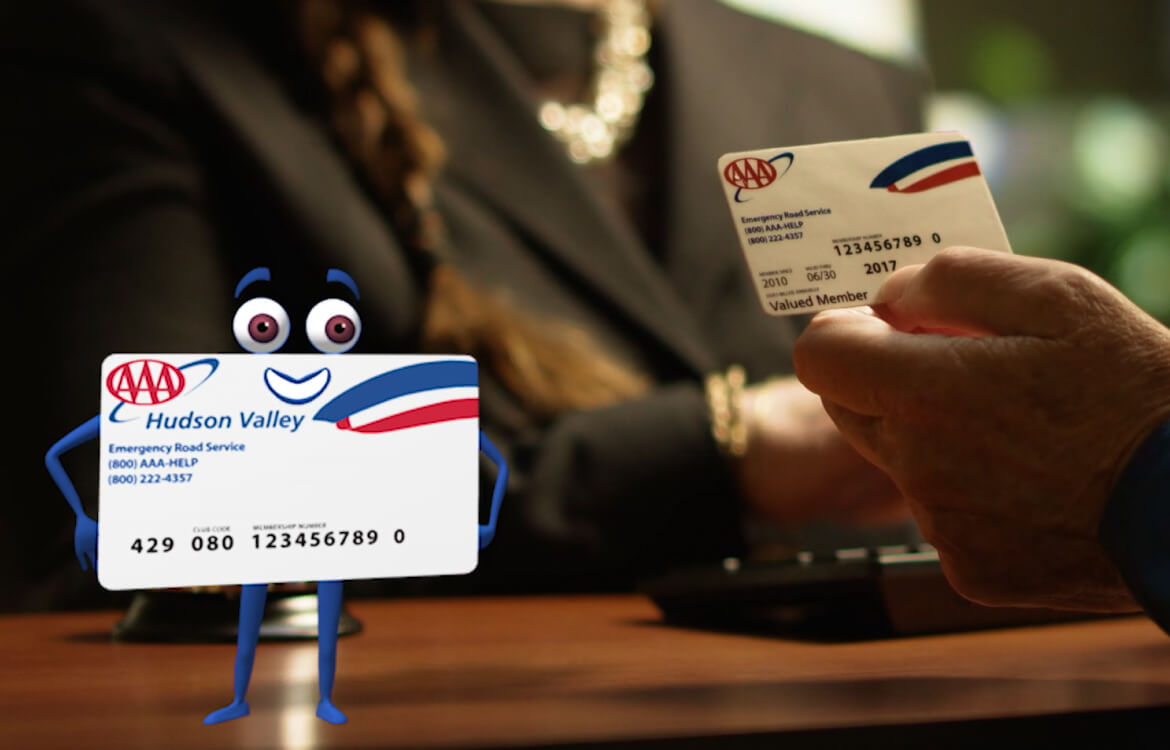 AAA card character standing in front of AAA member card held by a member