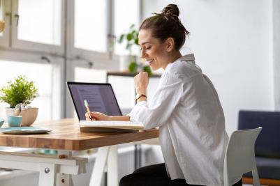 young woman doing taxes at desk