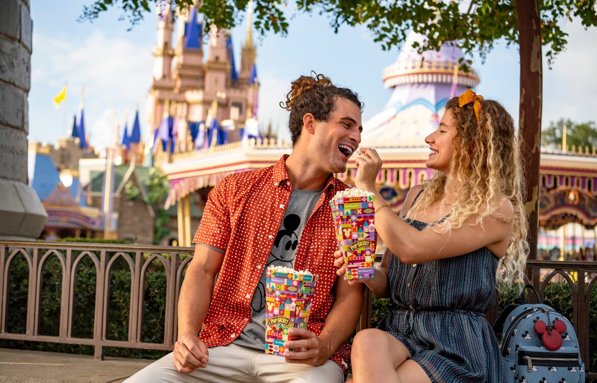 couple eating popcorn at disney