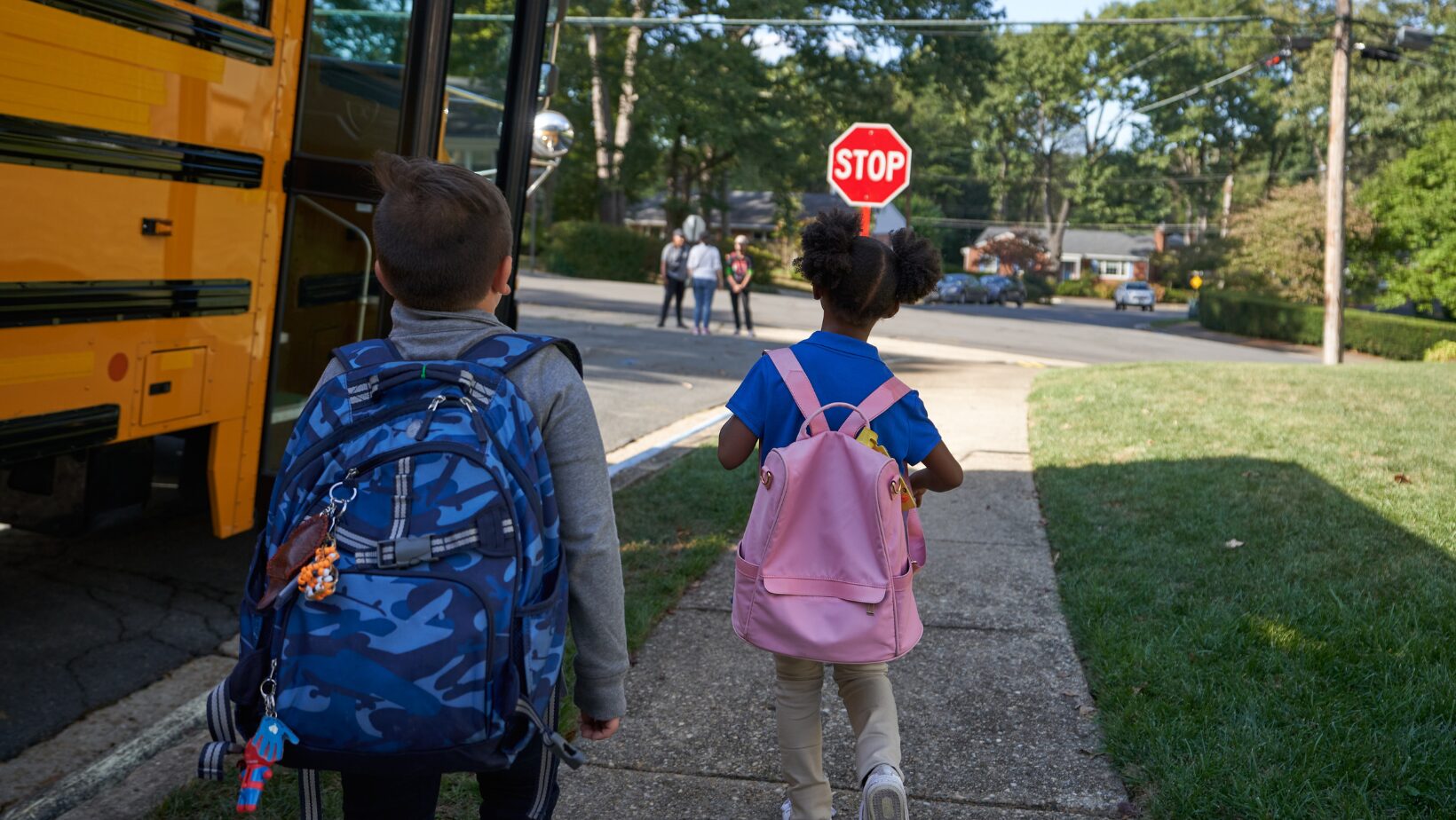 elementary aged kids getting on school bus