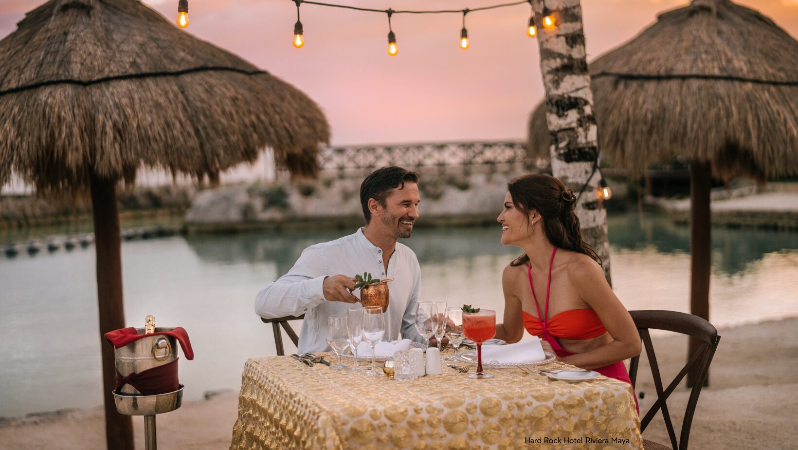 Couple on beach at romantic sunset dinner at Hard Rock Hotel Riviera Maya