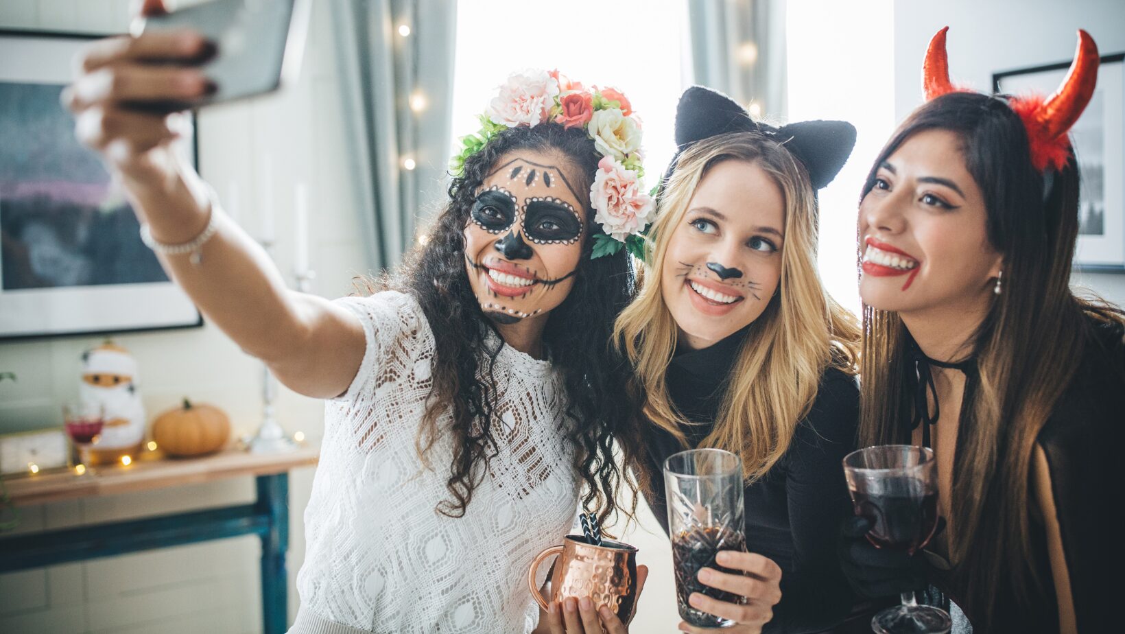 Women taking a selfie wearing Halloween costumes