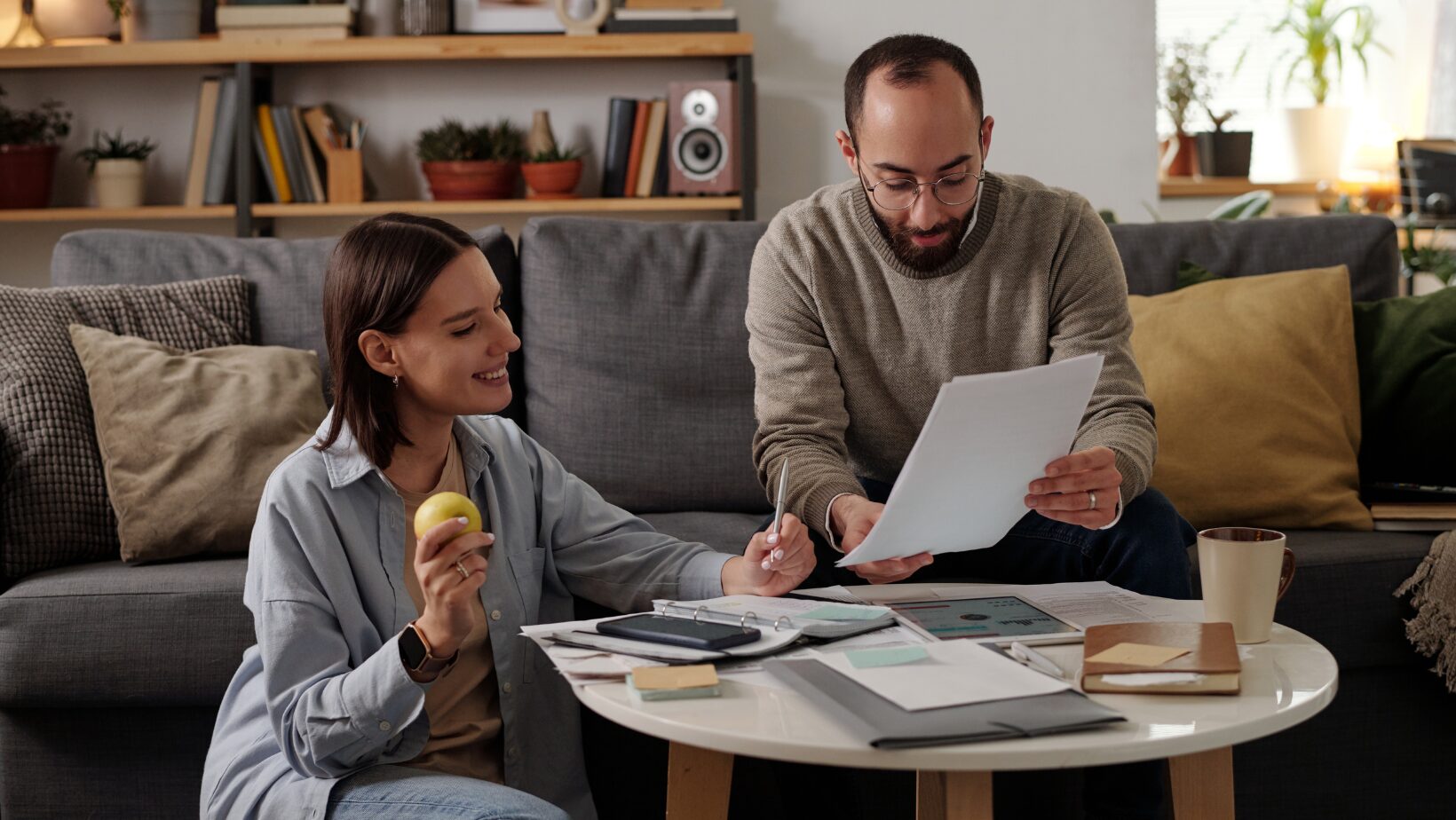 couple at home looking at financial documents